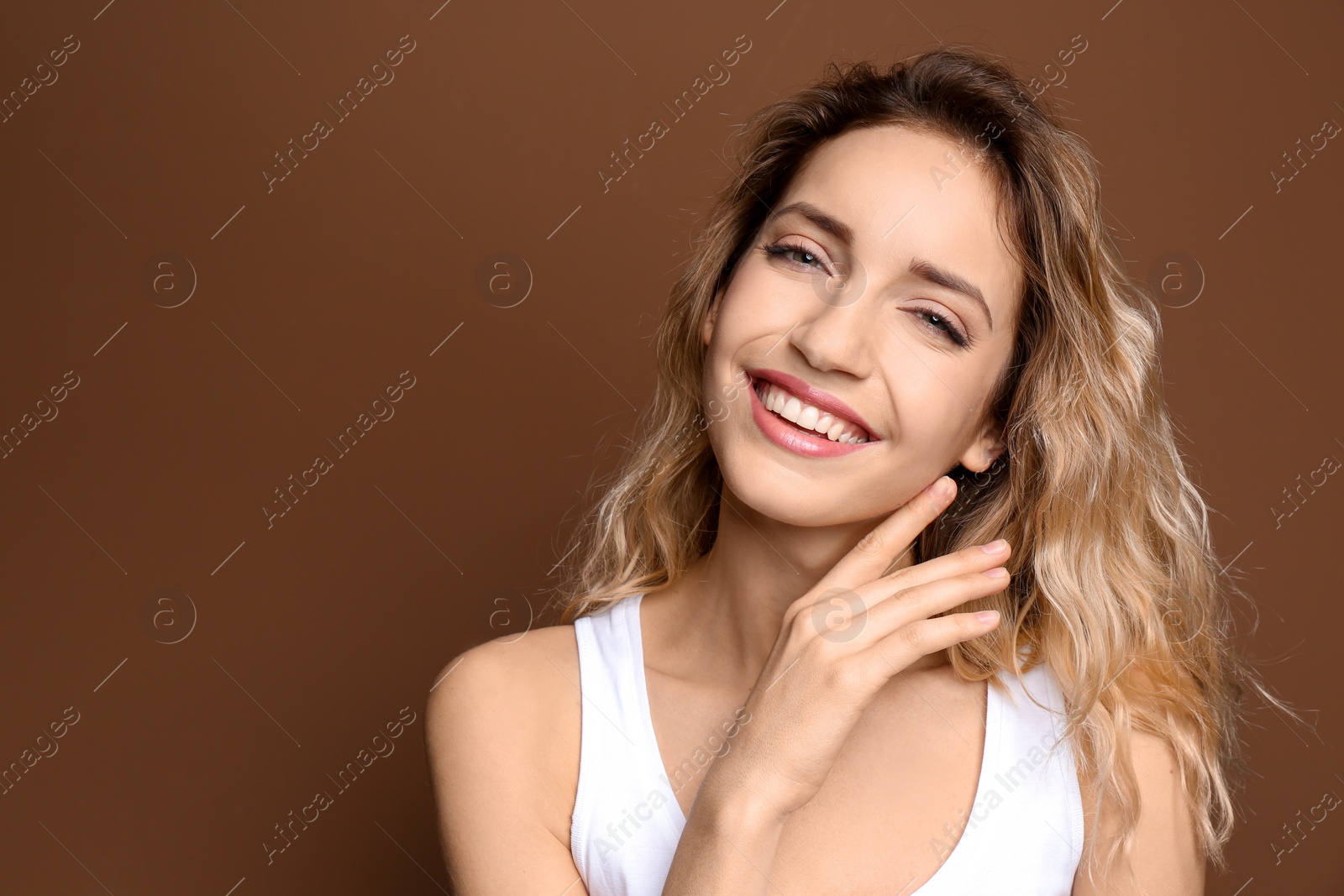 Photo of Young woman with beautiful smile on color background. Teeth whitening