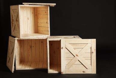 Photo of Group of wooden crates on black background