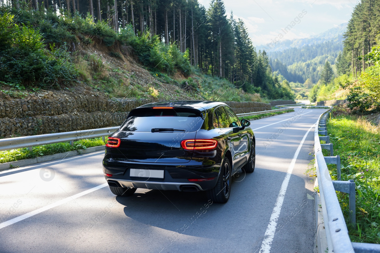 Photo of Picturesque view of asphalt road with modern car