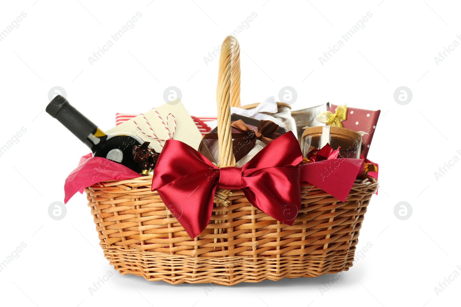 Photo of Wicker basket full of gifts isolated on white