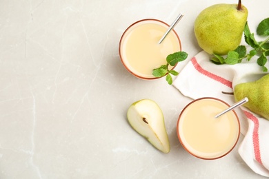 Photo of Tasty pear juice with mint and fruits on light grey marble table, flat lay. Space for text