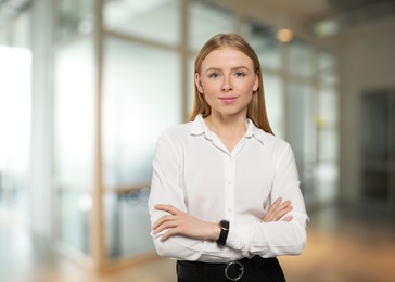 Portrait of confident woman in office. Pretty girl on blurred background