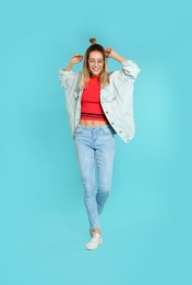 Photo of Full length portrait of emotional woman dancing on color background