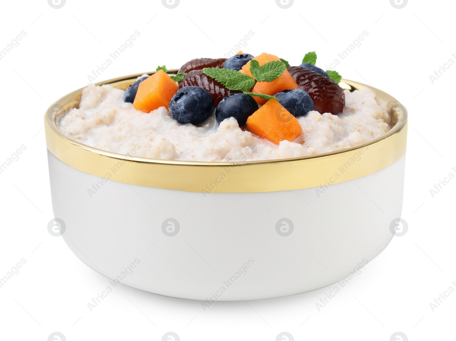 Photo of Delicious barley porridge with blueberries, pumpkin, dates and mint in bowl isolated on white