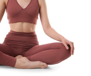 Woman in sportswear meditating on white background, closeup