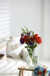 Photo of Vase with beautiful flowers on wooden table in room