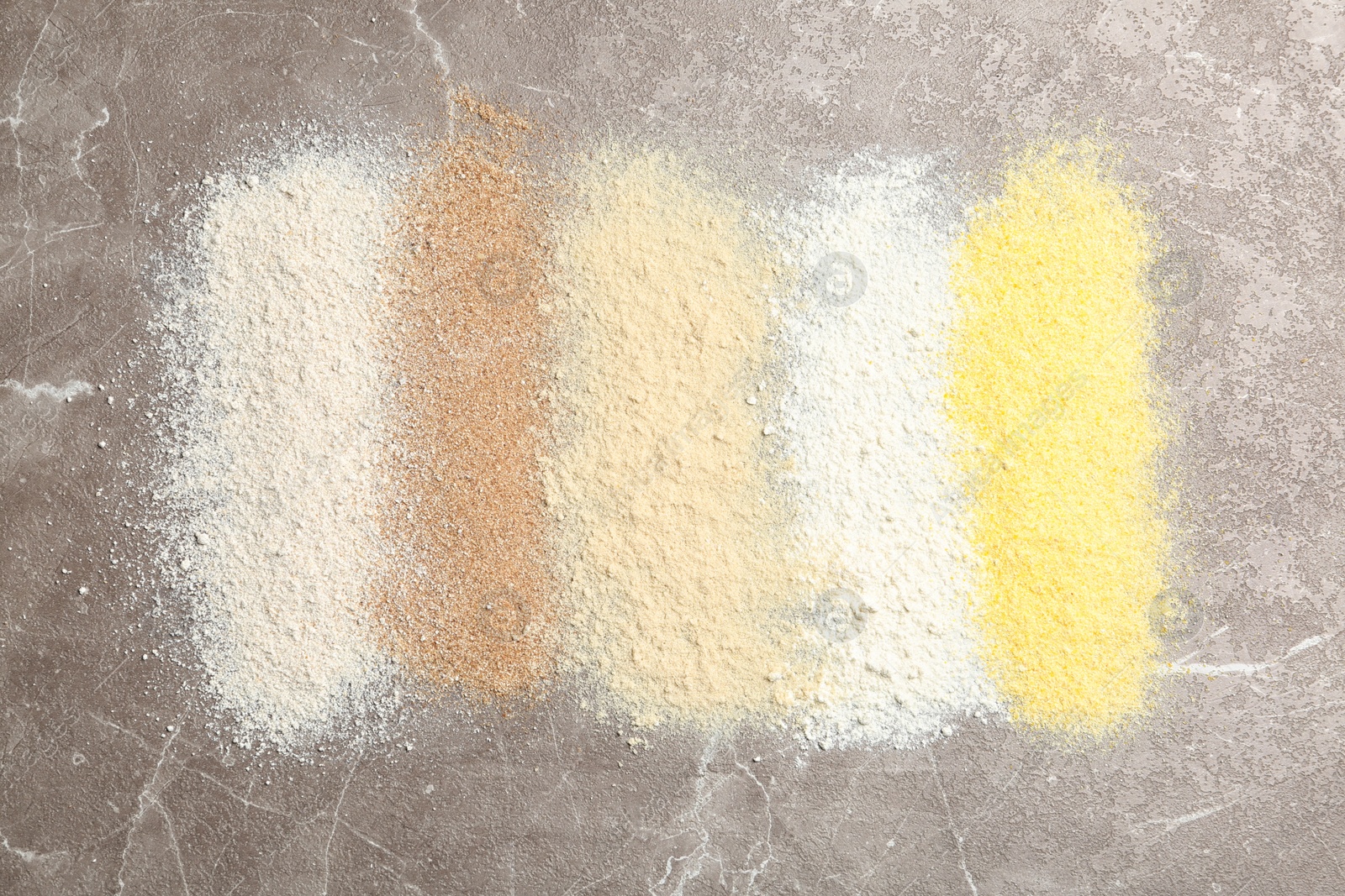 Photo of Stripes of different flour types on table, top view
