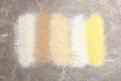 Stripes of different flour types on table, top view