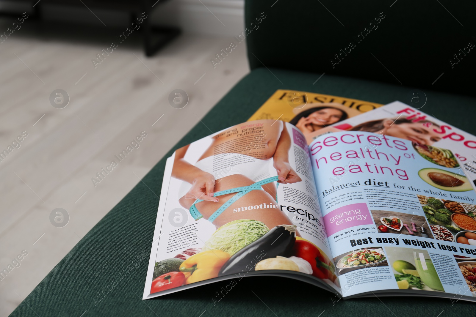 Photo of Different lifestyle magazines on comfortable sofa indoors