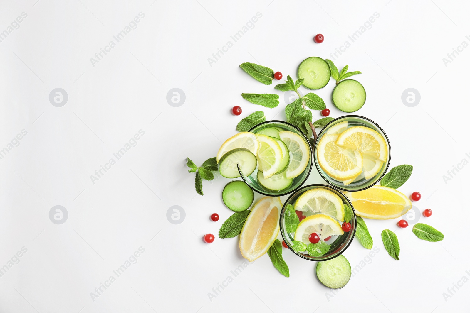 Photo of Flat lay composition with delicious natural lemonade on white background