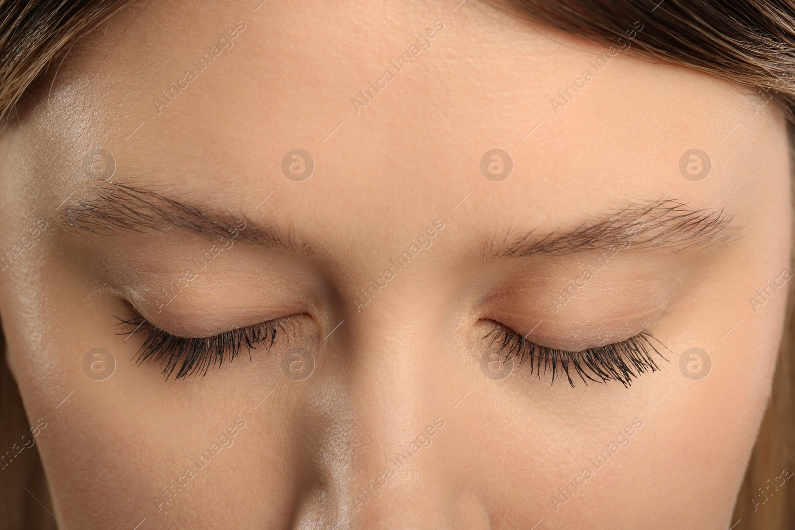 Photo of Woman with long eyelashes after mascara applying, closeup