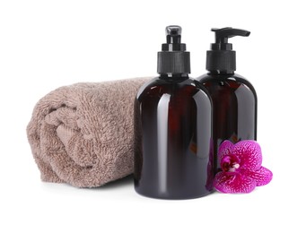 Photo of Bottles of shampoo and terry towel on white background