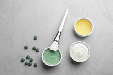 Photo of Flat lay composition with freshly made spirulina facial mask on light grey table