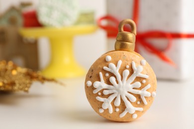 Beautifully decorated Christmas macaron on white table, space for text