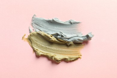 Photo of Samples of face mask on pink background, flat lay