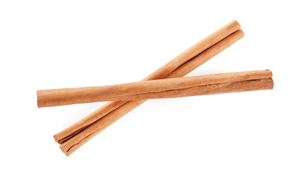 Photo of Aromatic cinnamon sticks on white background, top view