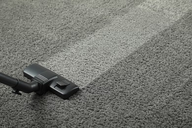 Image of Hoovering carpet with vacuum cleaner, space for text. Clean trace on dirty surface