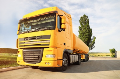 Modern yellow truck parked on country road