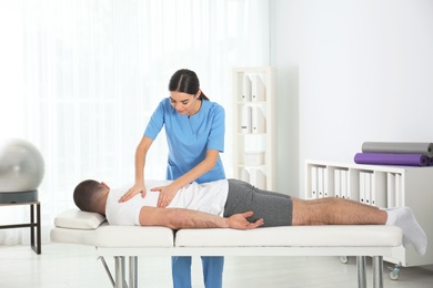 Doctor working with patient in hospital. Rehabilitation massage