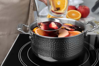 Delicious hot mulled wine in pot on stove