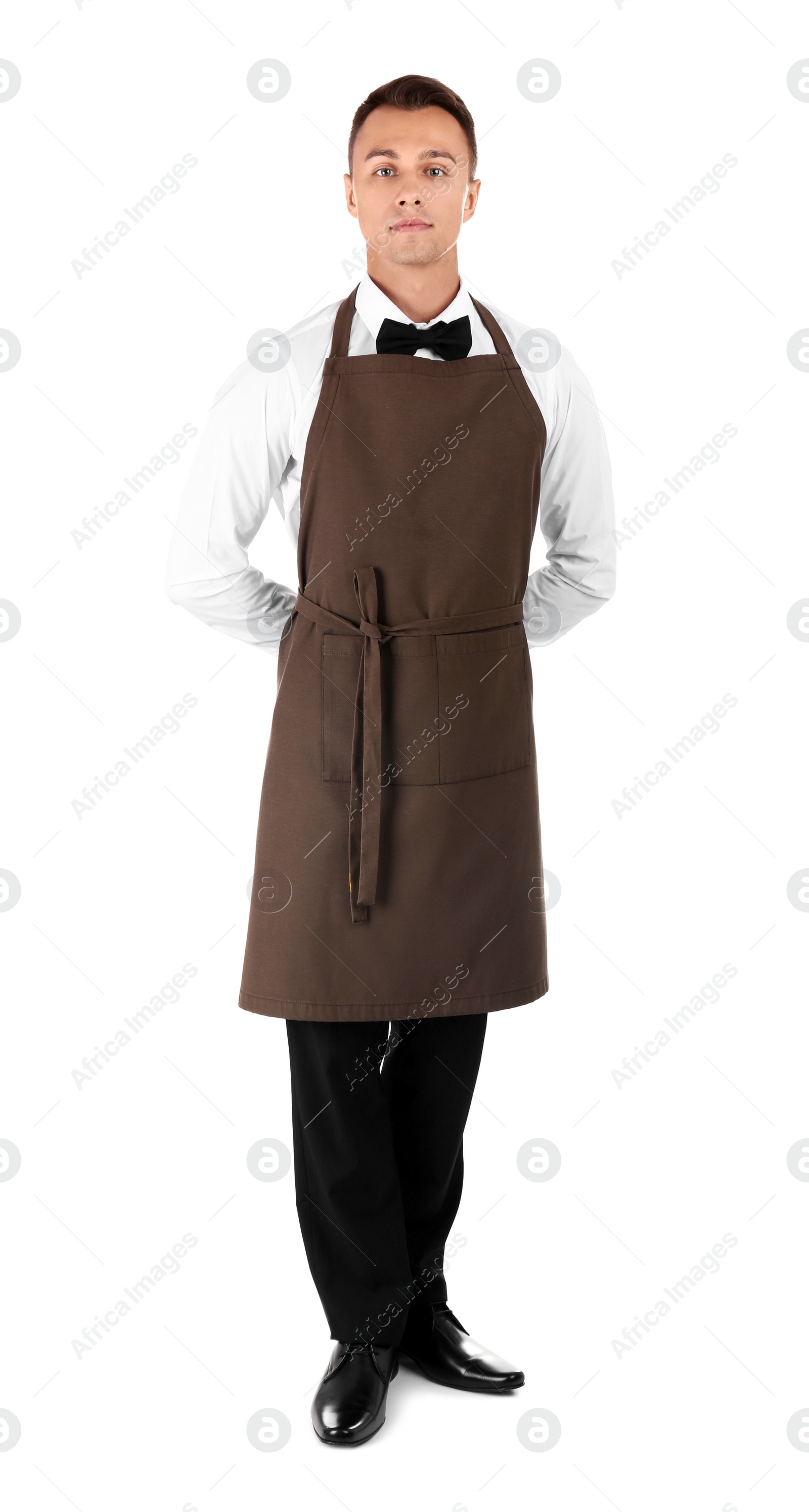 Photo of Full length portrait of young waiter in uniform on white background