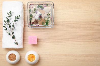 Photo of Composition with spa accessories and flowers on wooden background