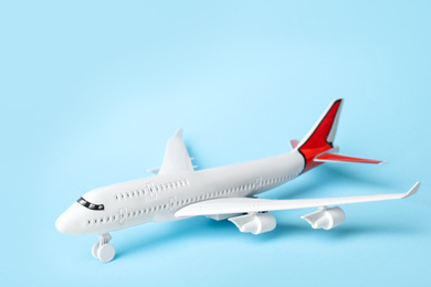 Photo of Toy plane on blue background. Logistics and wholesale concept