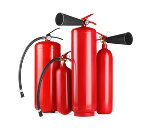 Photo of Many red fire extinguishers on white background