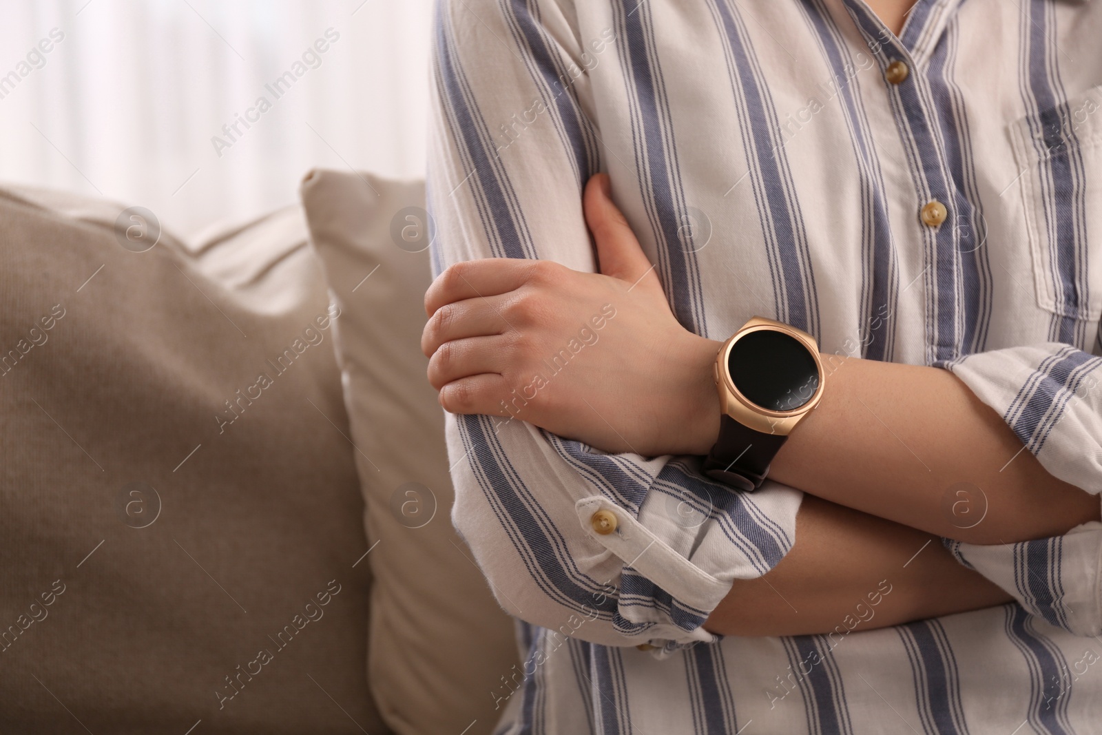 Photo of Young woman with smart watch at home, closeup