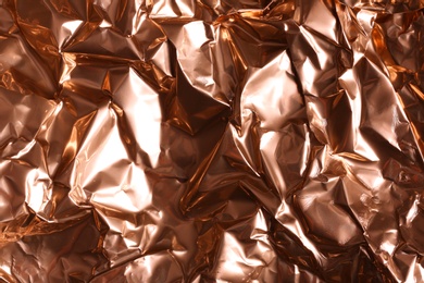 Crumpled rose gold foil as background, closeup view