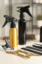 Photo of Hairdresser tools. Different scissors and combs on white table in salon