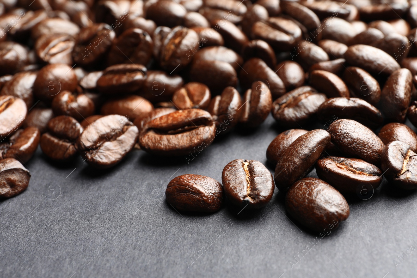 Photo of Roasted coffee beans on grey background, closeup