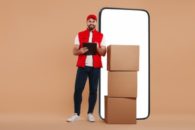 Courier with stack of parcels and clipboard near huge smartphone on dark beige background. Delivery service