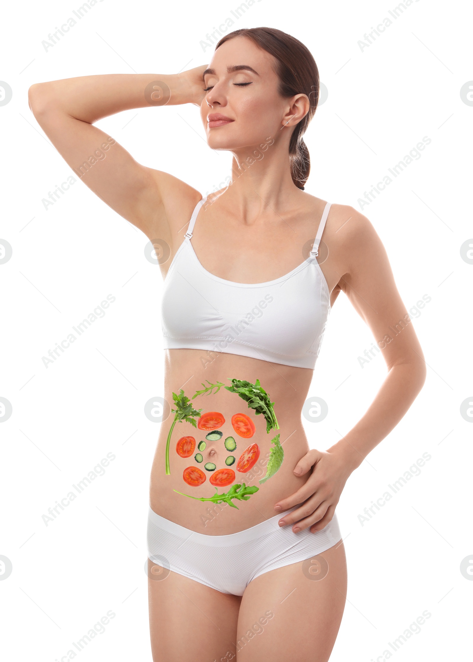 Image of Slim young woman and images of vegetables on her belly against white background. Healthy eating