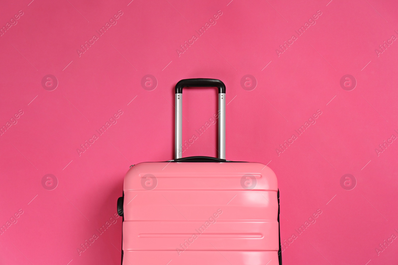 Photo of Stylish suitcase on color background, top view