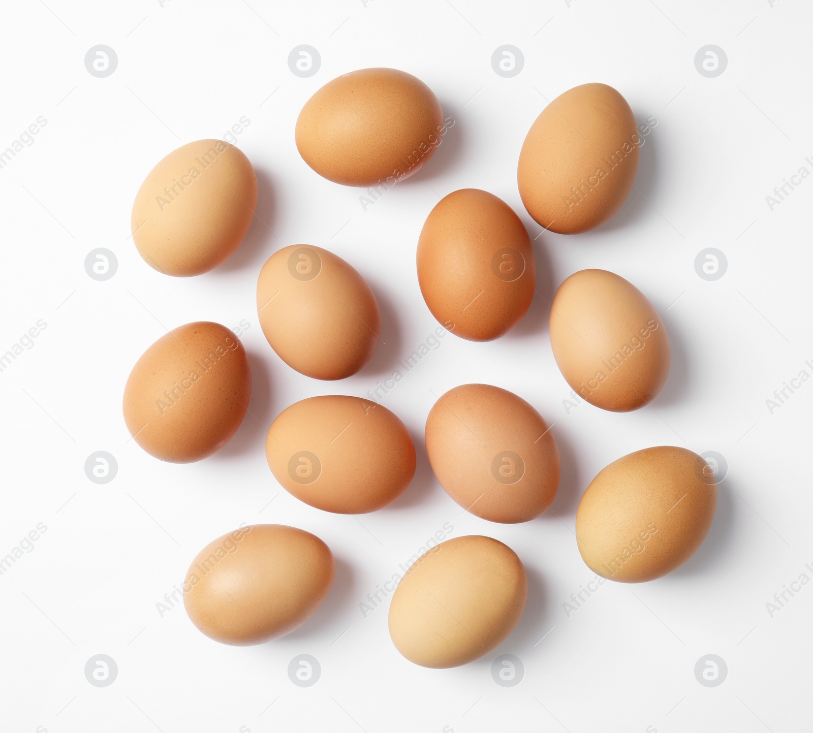 Photo of Raw chicken eggs on white background, top view