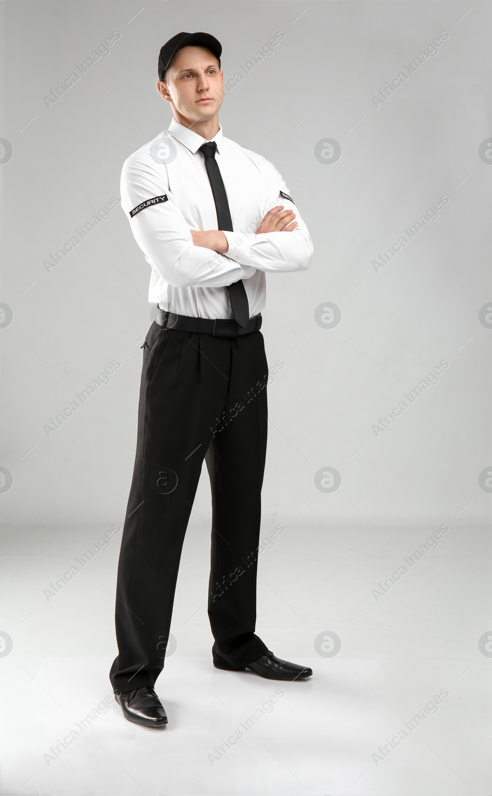 Photo of Male security guard in uniform on color background