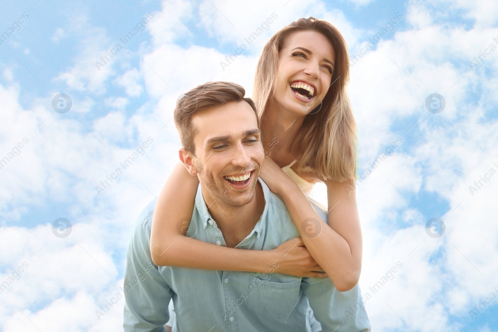 Photo of Cute young couple in love posing on light background