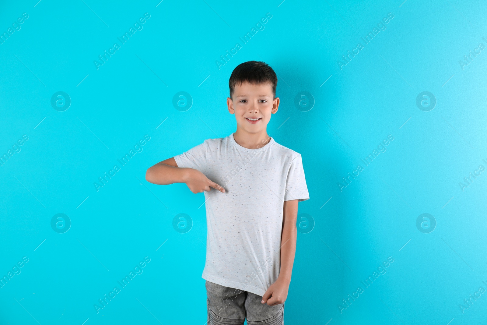 Photo of Little boy in t-shirt on color background. Mock-up for design