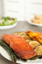 Delicious cooked salmon and vegetables on grey table, space for text. Healthy meals from air fryer