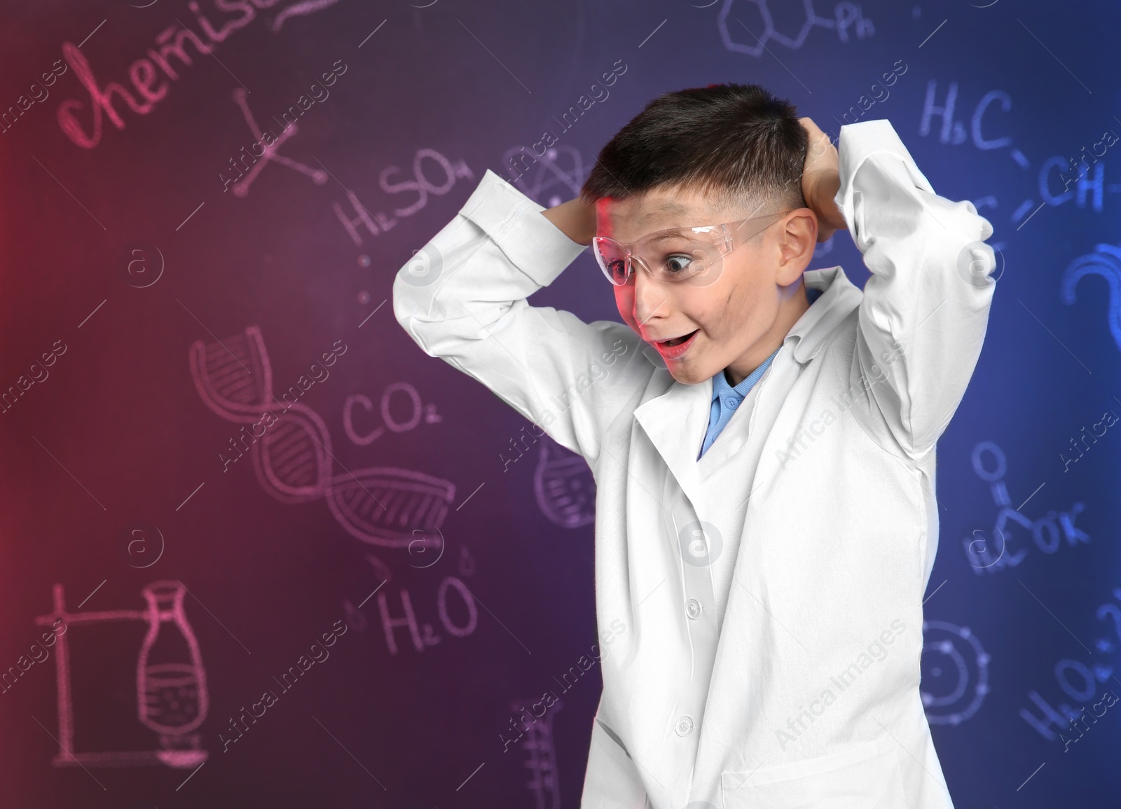 Photo of Emotional pupil against blackboard with written chemistry formulas. Space for text