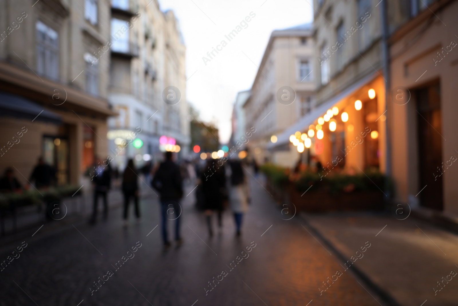 Photo of Blurred view of people walking on city street