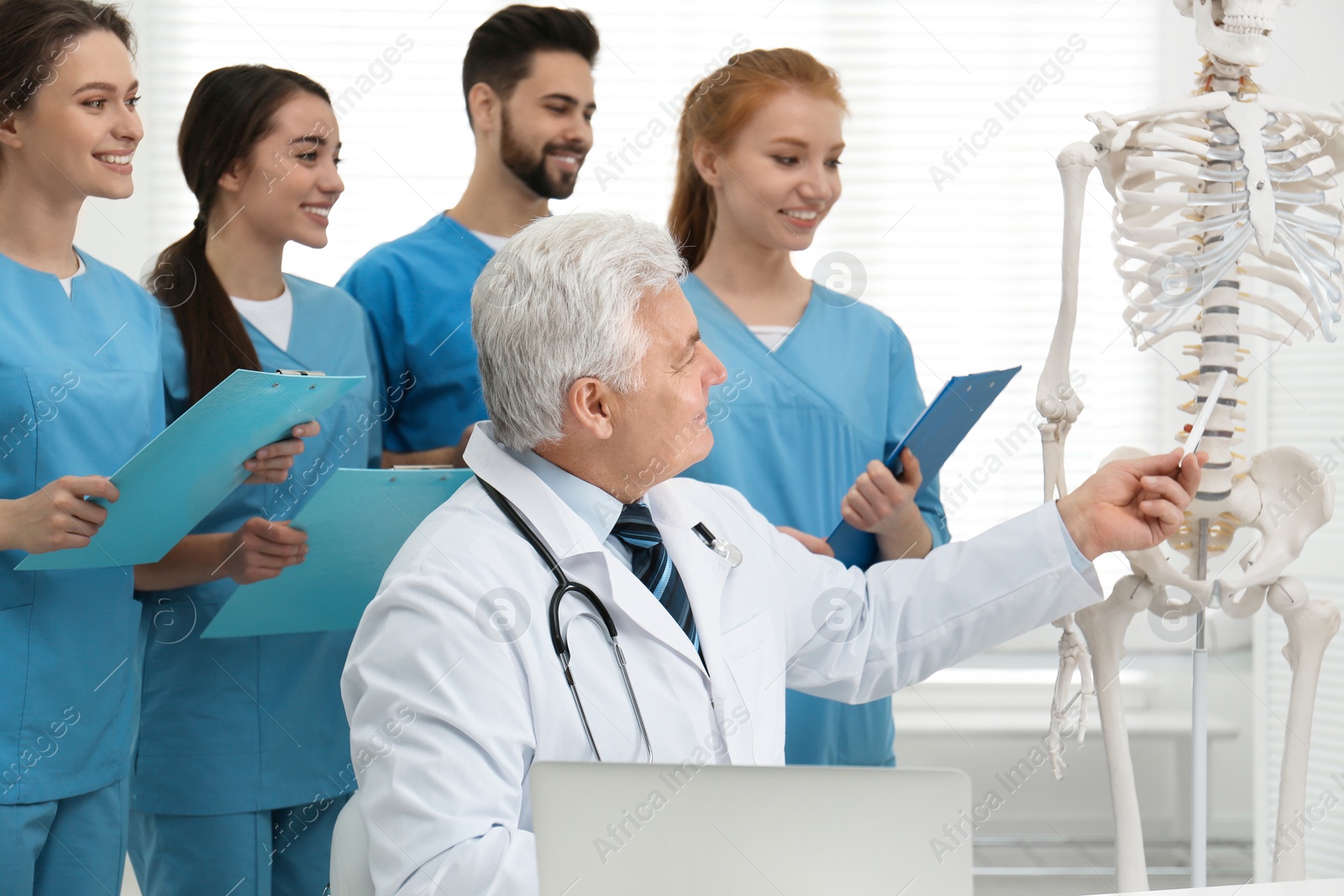 Photo of Professional orthopedist teaching medical students in clinic