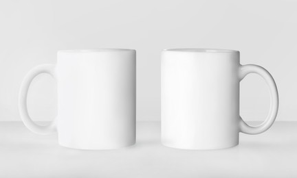 Image of Blank ceramic mugs on white background. Mockup for design