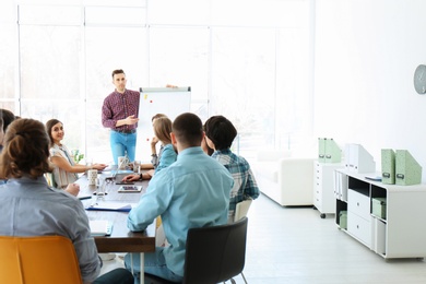 Photo of Male business trainer giving lecture in office
