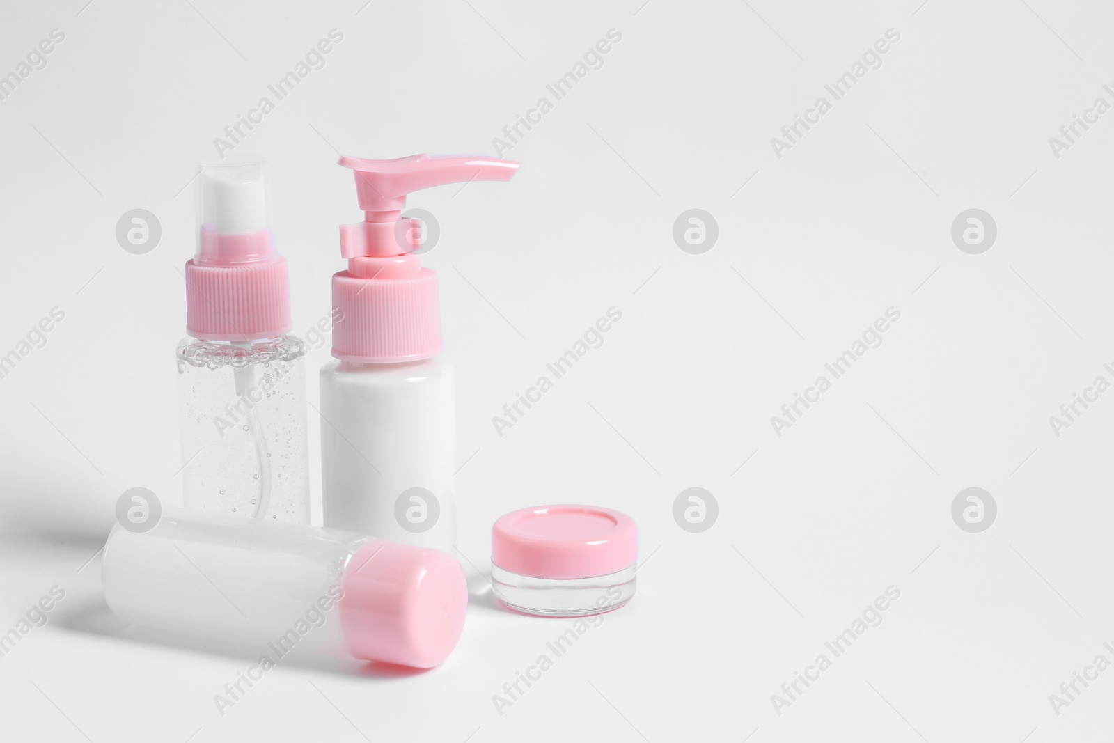 Photo of Cosmetic travel kit on white background. Space for text