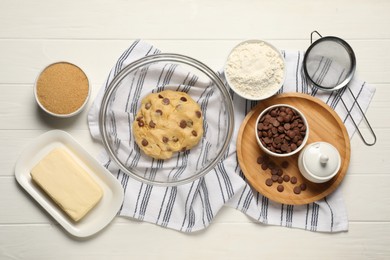 Fresh dough and different ingredients for cooking chocolate chip cookies on white wooden table, flat lay