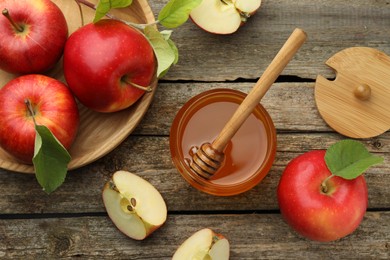 Photo of Sweet honey and fresh apples on wooden table, flat lay