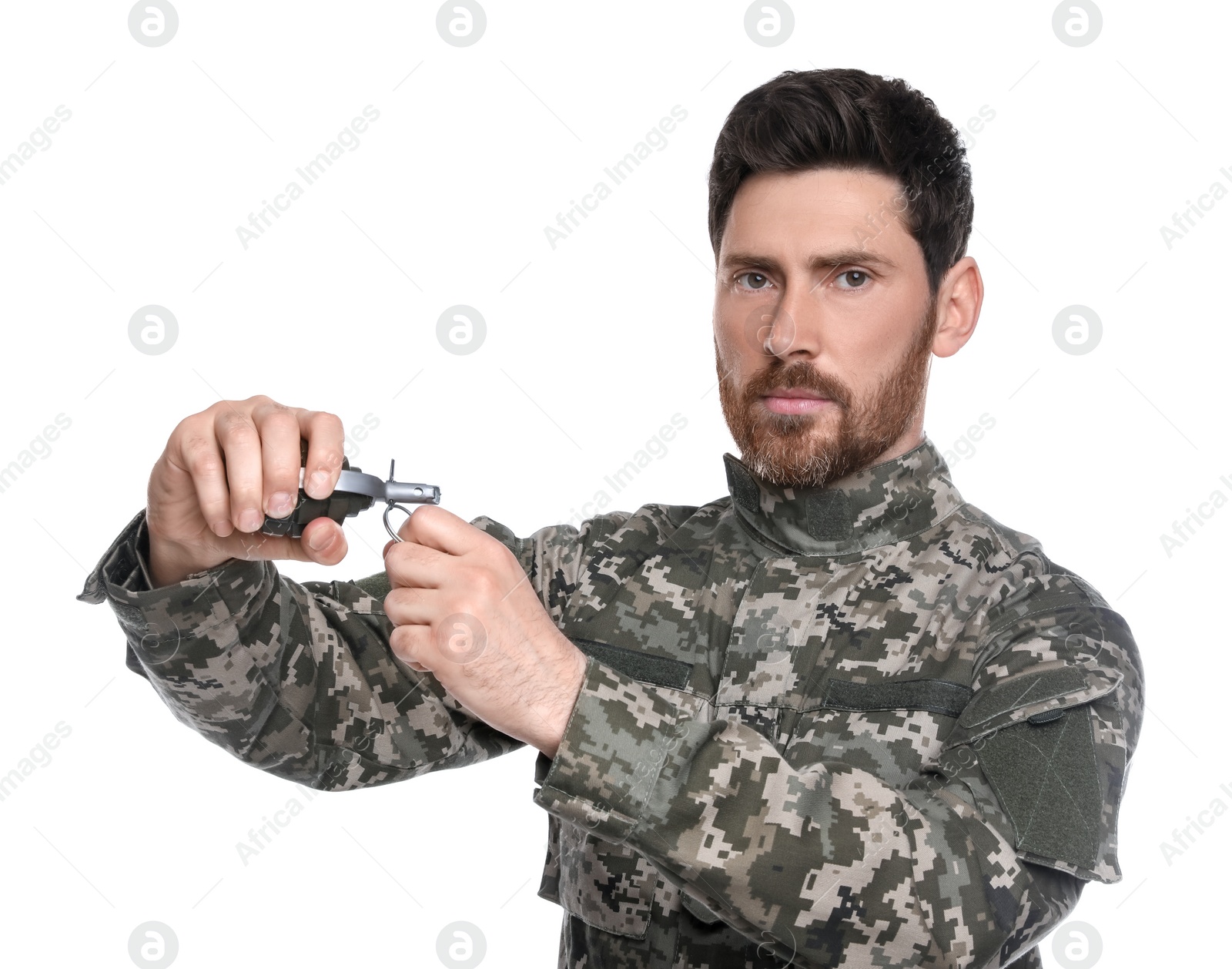 Photo of Soldier pulling safety pin out of hand grenade on white background. Military service