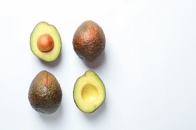 Composition with ripe fresh avocados on white background